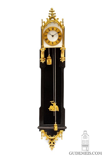 A miniature Austrian Neo Gothic ebonized ormolu mounted brettl wall clock, circa 1840.